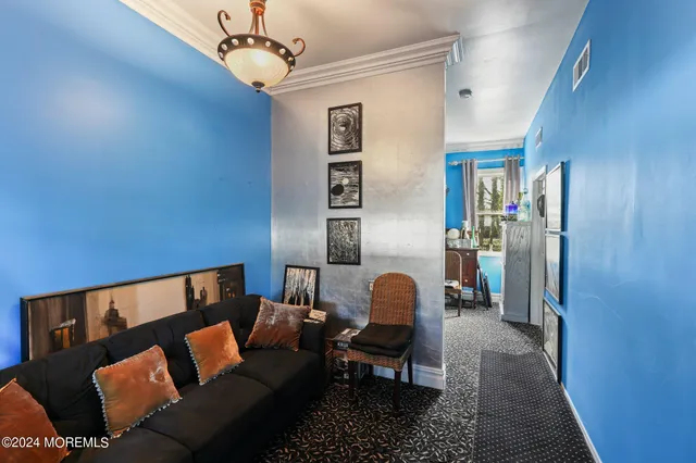 a living room with furniture and a chandelier