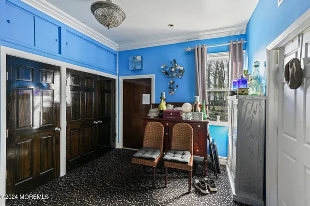 a room with furniture a refrigerator and a window