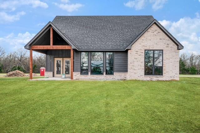 25 Private Road Blossom, TX 75416 - Photo 5 of 7 a front view of a house with a yard and garage