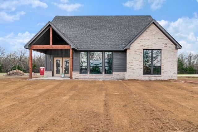 25 Private Road Blossom, TX 75416 - Photo 6 of 7 a view of a house with a yard and potted plants