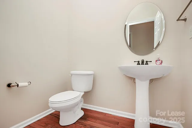 a bathroom with a sink toilet and mirror