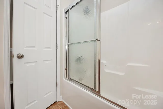 a bathroom with a glass shower door