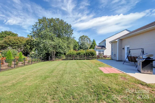 a swimming pool with some trees in the background