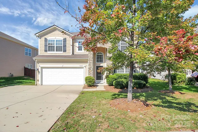 a front view of a house with a yard and garage