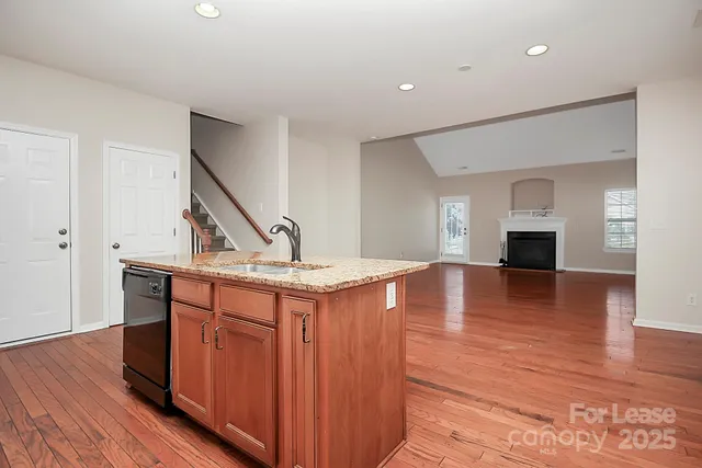 a kitchen view with wooden floor and staircase
