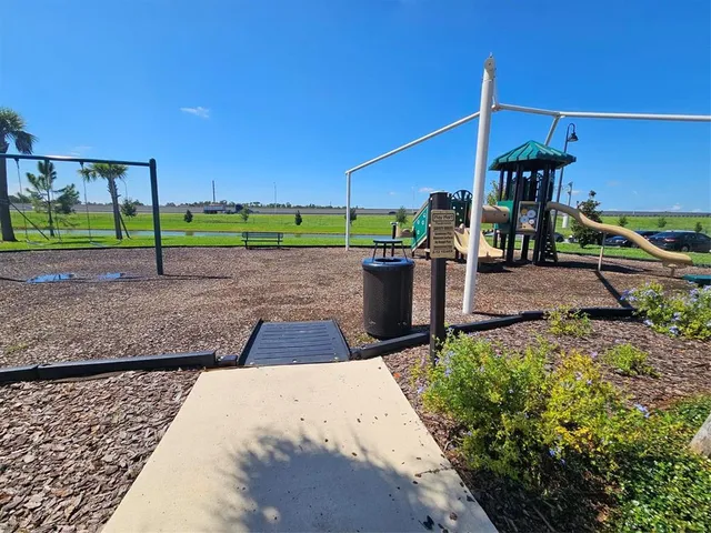 a white house with a yard and wooden fence