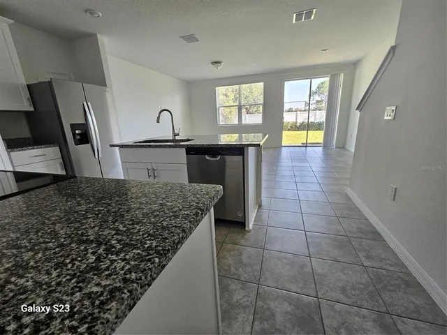 a view of a kitchen with a sink and a window