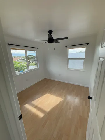 an empty room with windows and closet
