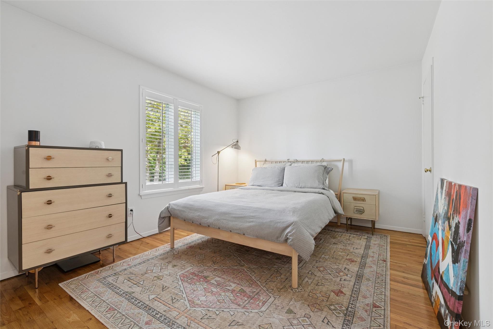 4 Morris Court Westhampton Beach, NY 11978 - Photo 11 of 28 a bedroom with a bed and a dresser