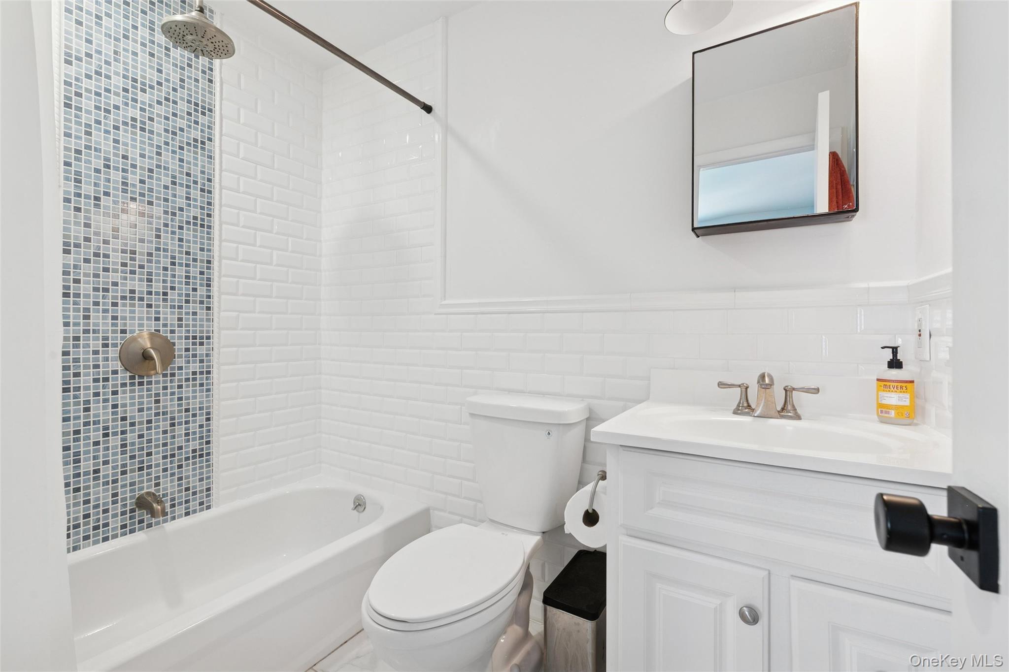 4 Morris Court Westhampton Beach, NY 11978 - Photo 12 of 28 a bathroom with a sink a toilet and a bathtub