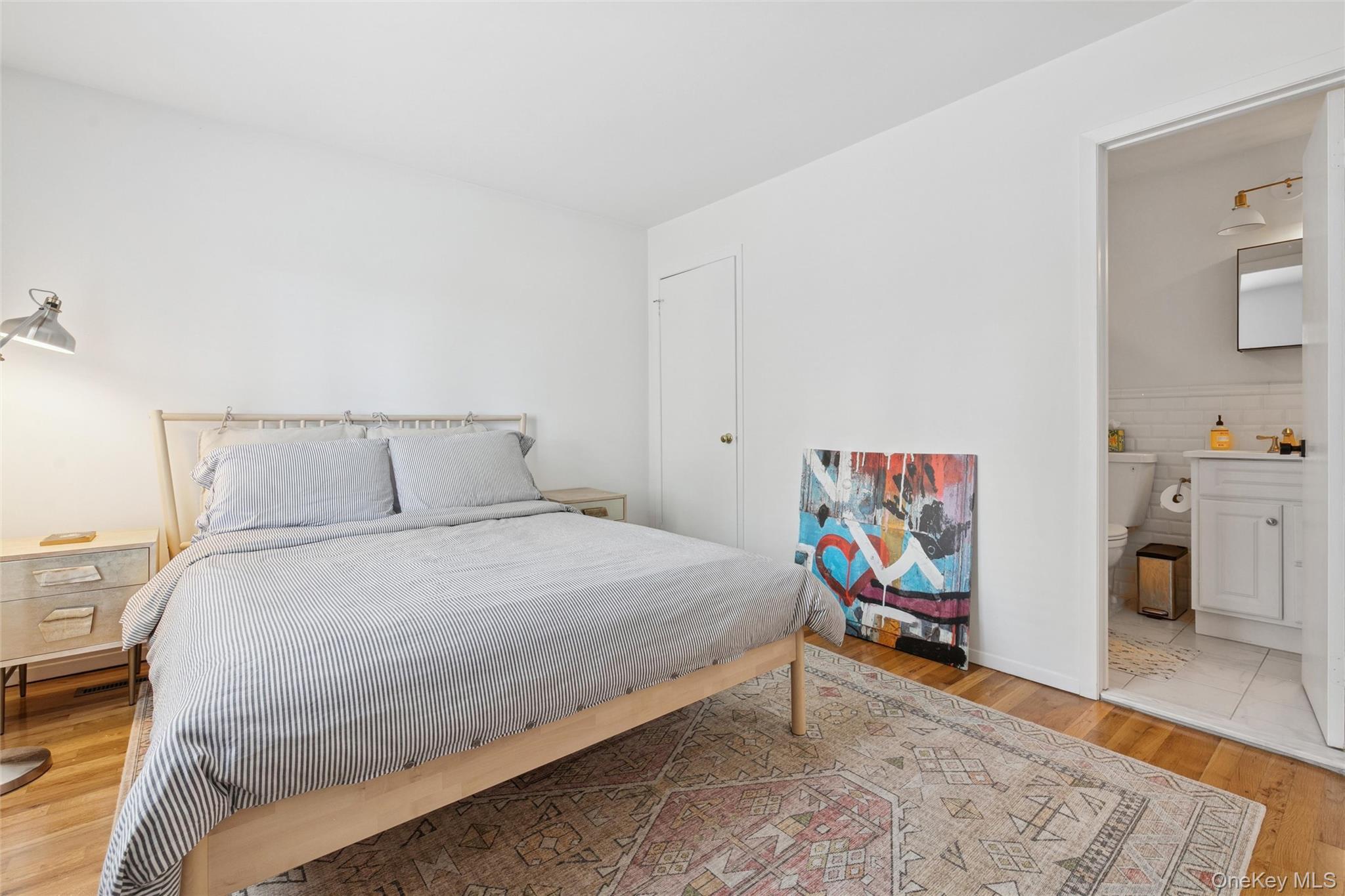 4 Morris Court Westhampton Beach, NY 11978 - Photo 13 of 28 a bedroom with a bed and wooden floor