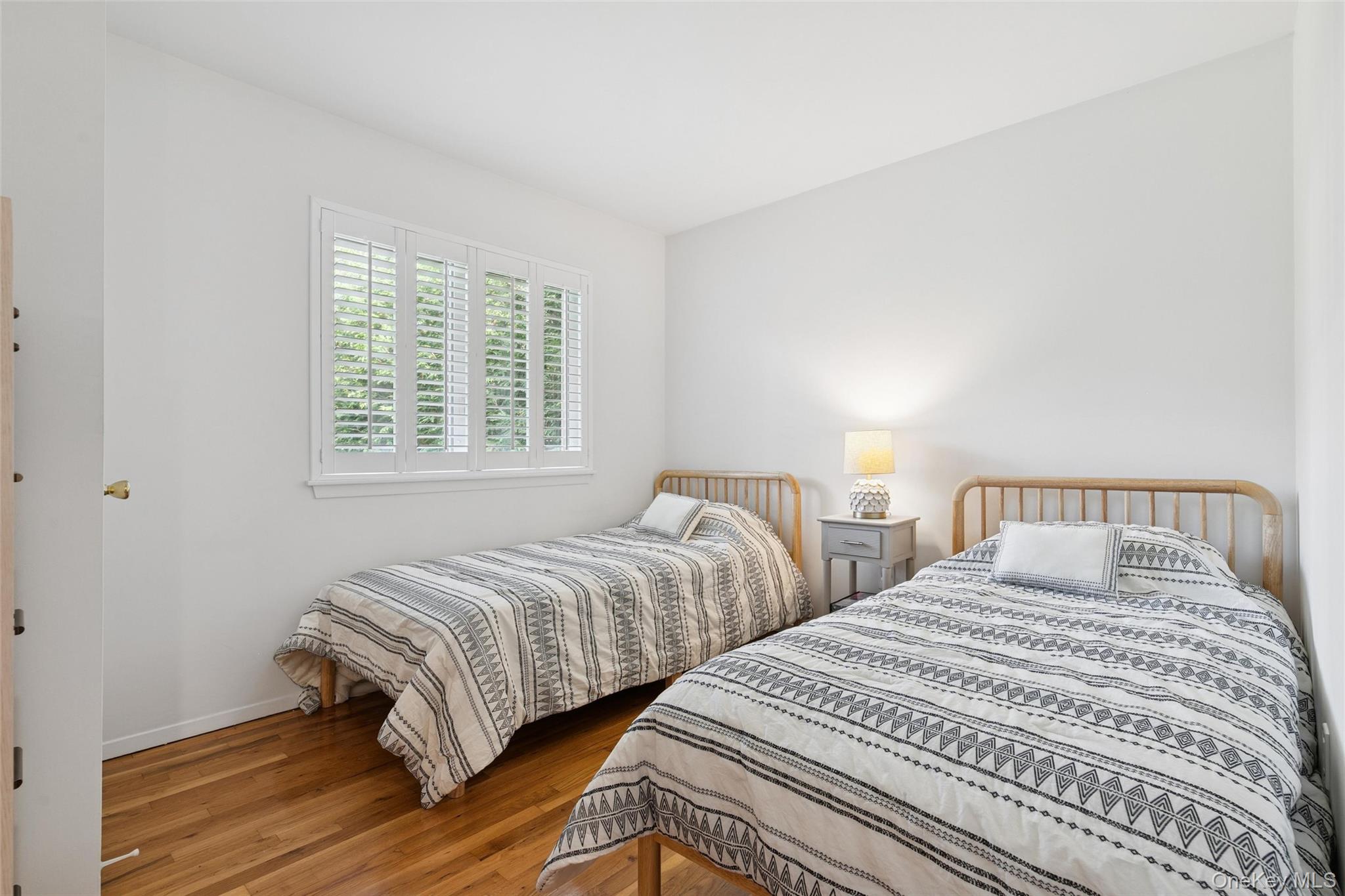 4 Morris Court Westhampton Beach, NY 11978 - Photo 14 of 28 a bedroom with two beds and a window