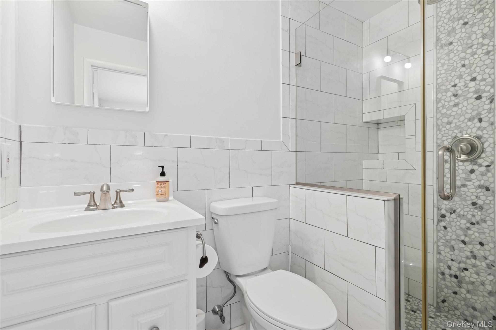 4 Morris Court Westhampton Beach, NY 11978 - Photo 17 of 28 a bathroom with a toilet sink shower and mirror