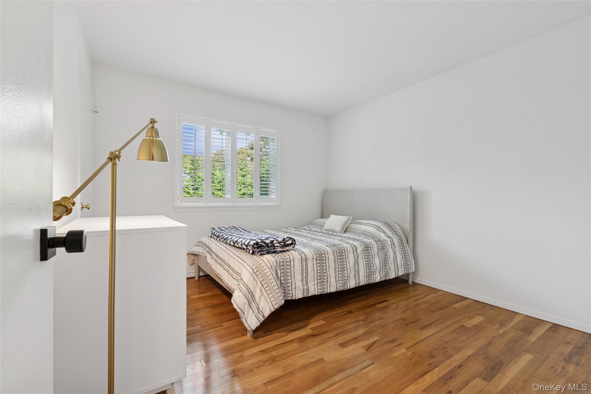 4 Morris Court Westhampton Beach, NY 11978 - Photo 18 of 28 a bedroom with a bed and a window