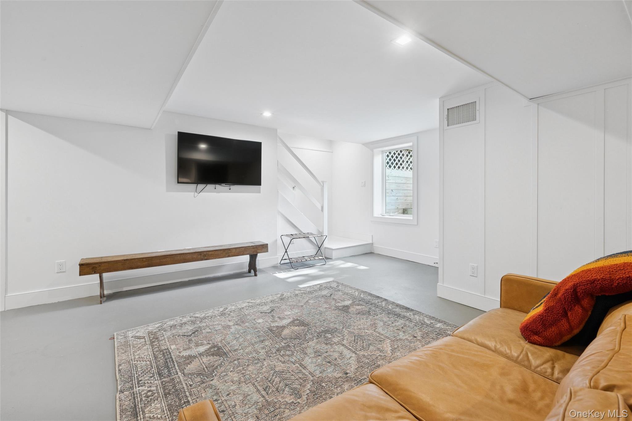 4 Morris Court Westhampton Beach, NY 11978 - Photo 21 of 28 a living room with furniture and a flat screen tv