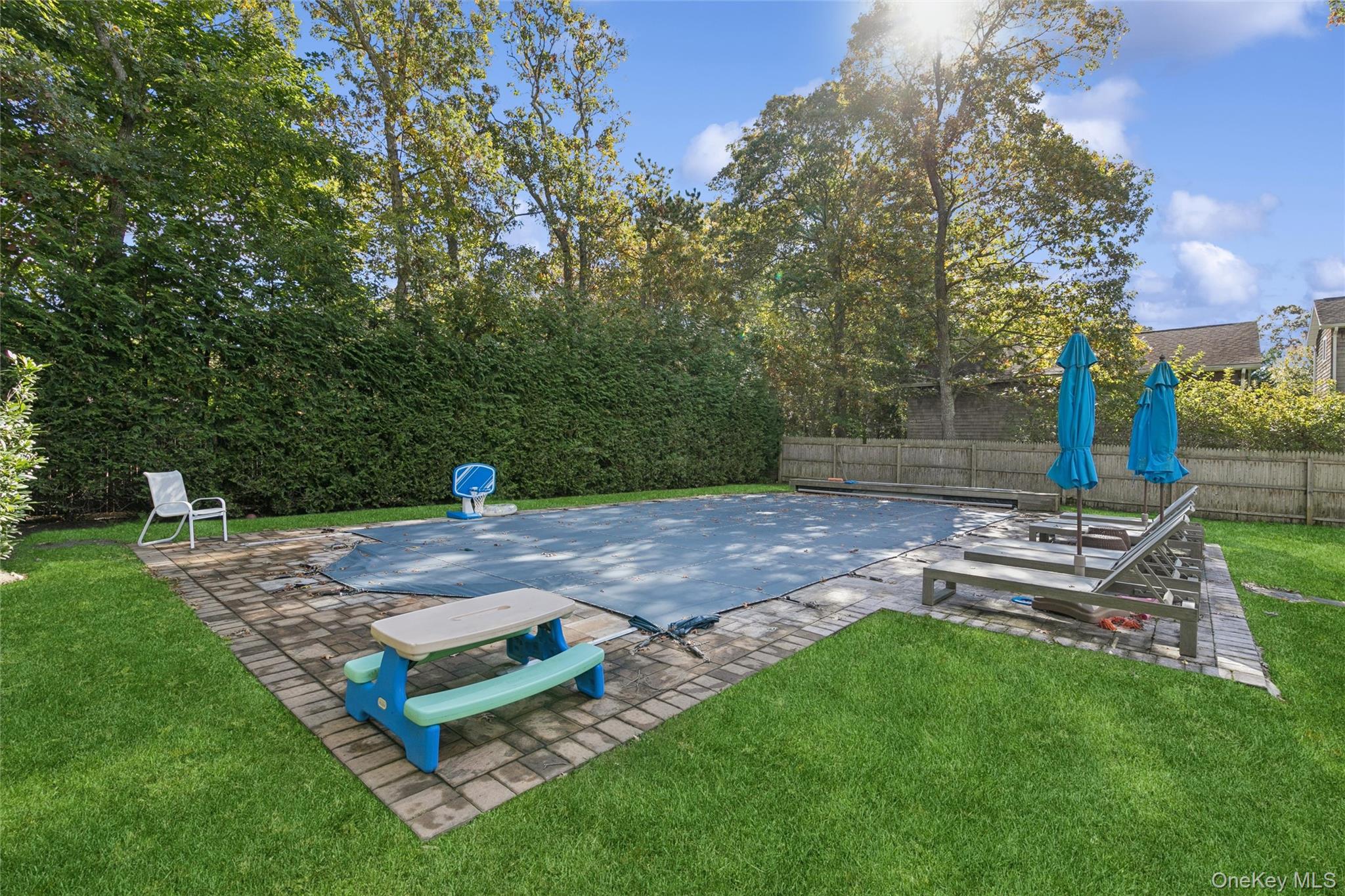 4 Morris Court Westhampton Beach, NY 11978 - Photo 24 of 28 a view of a backyard with wooden fence