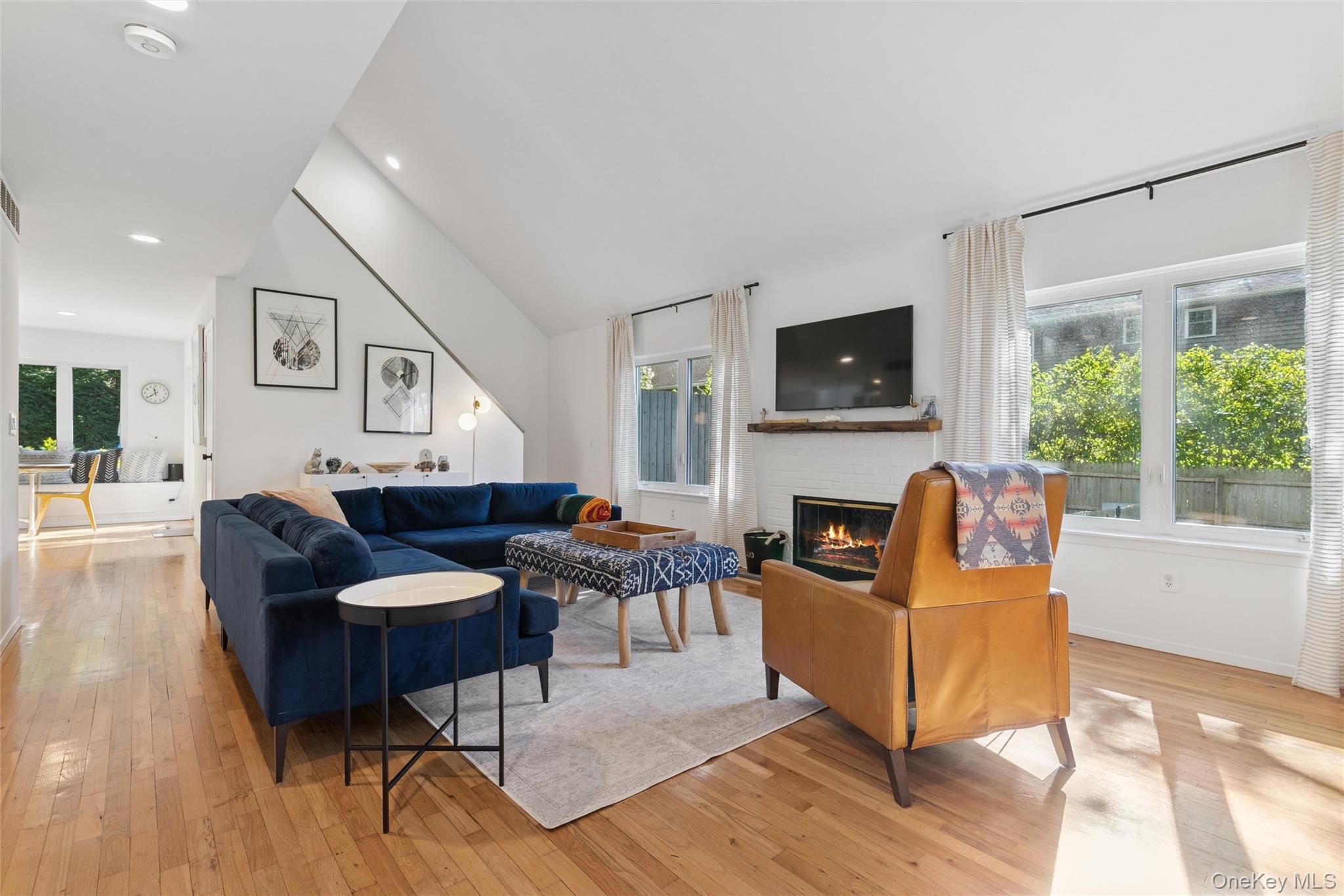 4 Morris Court Westhampton Beach, NY 11978 - Photo 5 of 28 a living room with furniture a flat screen tv and a fireplace