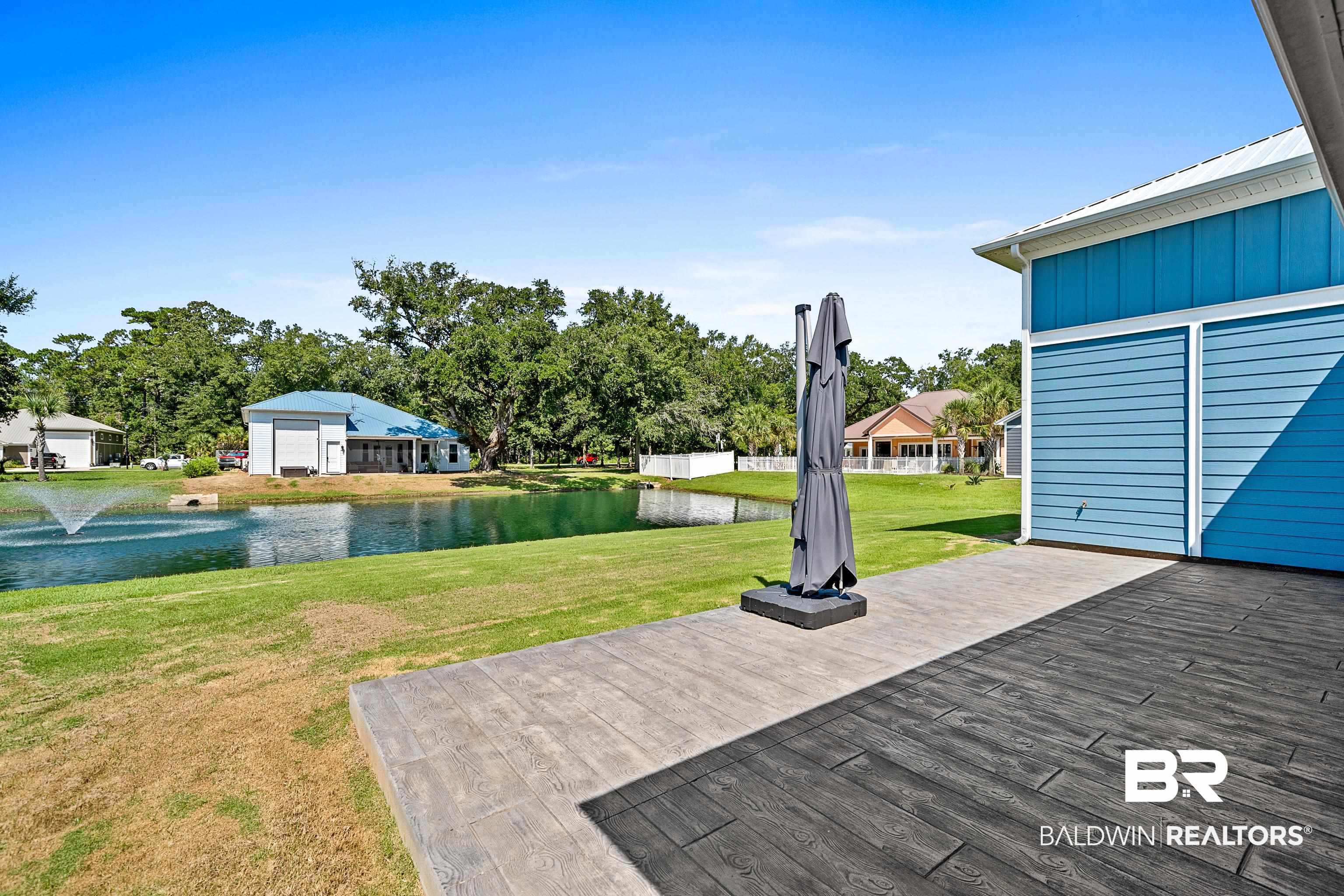 12329 Reunion Place, Unit LOT 38 Foley, AL 36535 - Photo 31 of 43 Deck with a water view and a yard