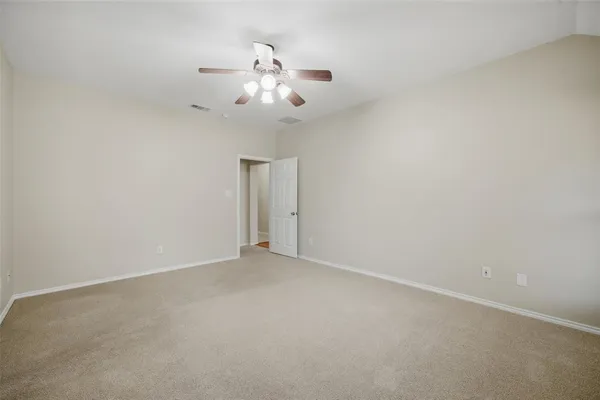 en empty room with chandelier fan