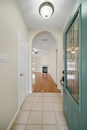 a room with a large window and chandelier