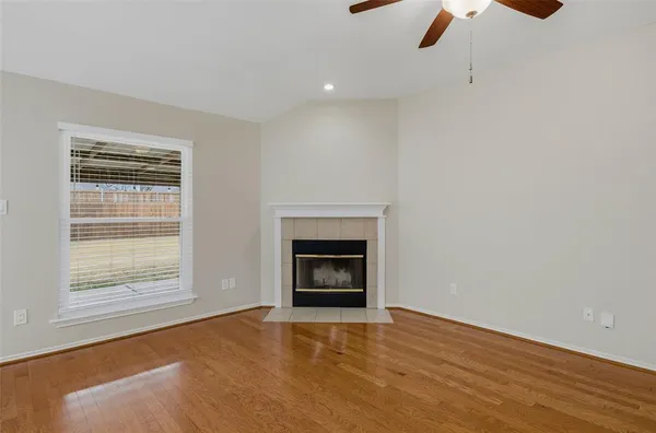a view of empty room with a fireplace