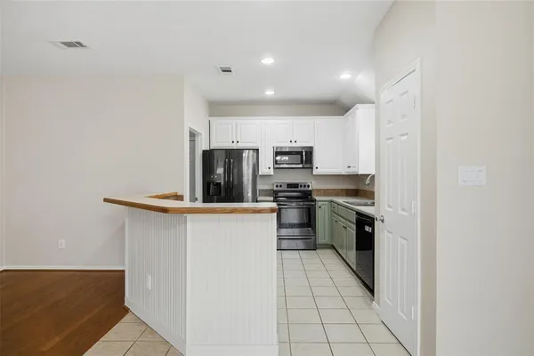 a kitchen with stainless steel appliances a refrigerator sink and stove
