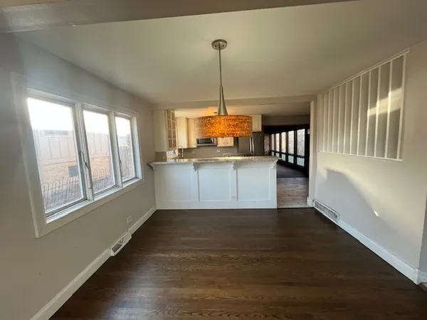 a kitchen with stainless steel appliances granite countertop a stove a sink and a window