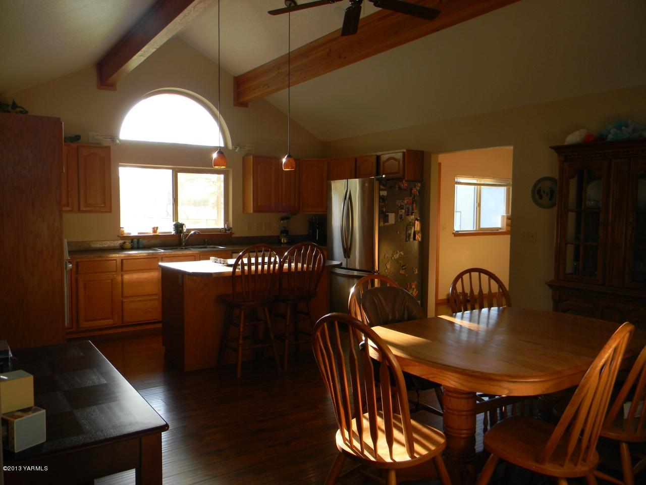 1805 Ekelman Road Yakima, WA 98901 - Photo 5 of 16 a kitchen with a table chairs sink and cabinets