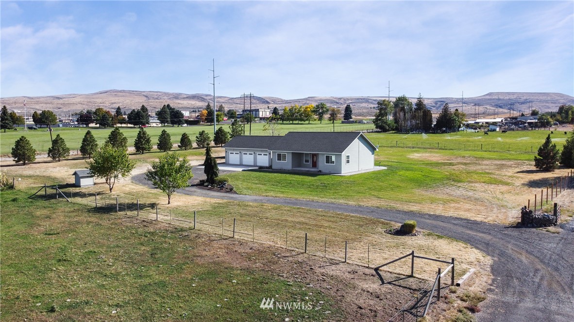 704 Firing Center Road Yakima, WA 98901 - Photo 2 of 29 a view of a house with a yard and sitting area