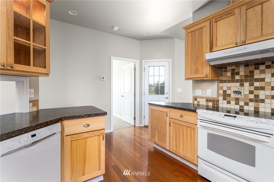 704 Firing Center Road Yakima, WA 98901 - Photo 12 of 29 a kitchen with stainless steel appliances granite countertop a sink and cabinets