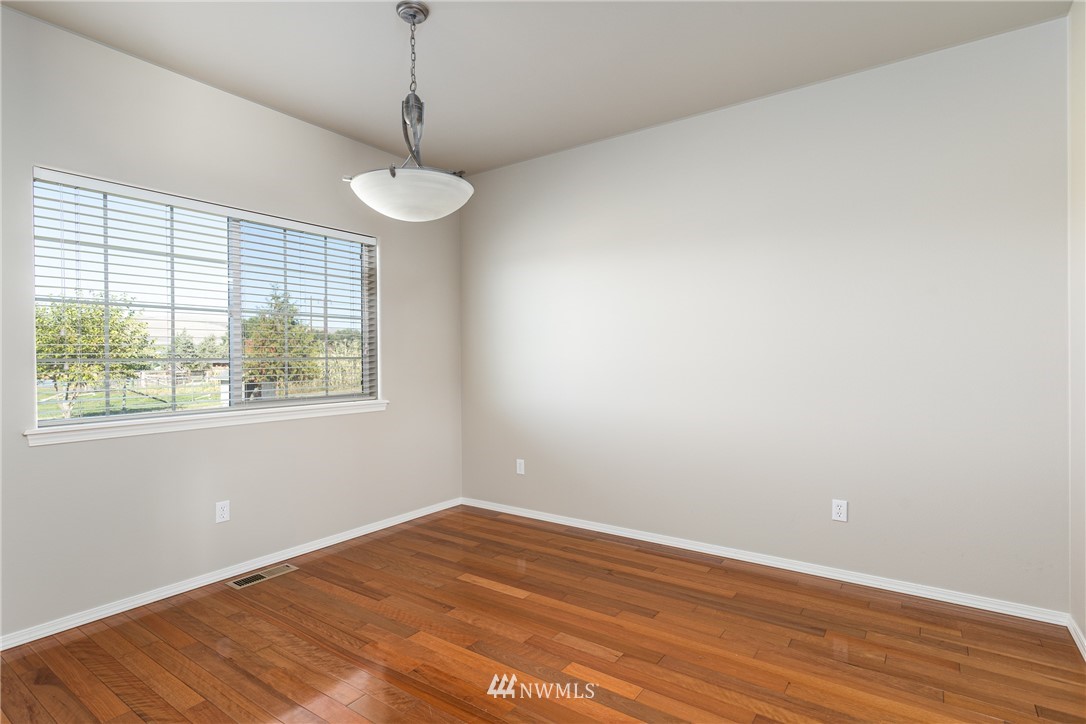 704 Firing Center Road Yakima, WA 98901 - Photo 13 of 29 a view of an empty room with wooden floor and a window