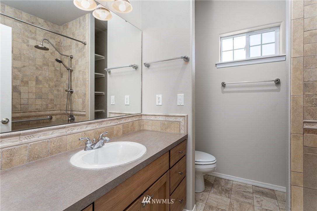 704 Firing Center Road Yakima, WA 98901 - Photo 20 of 29 a bathroom with a sink toilet a mirror and shower