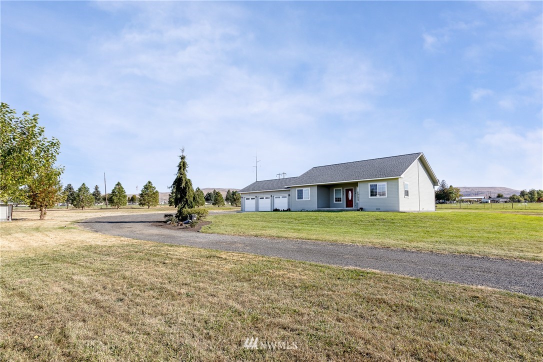 704 Firing Center Road Yakima, WA 98901 - Photo 3 of 29 a front view of a house with a yard and trees