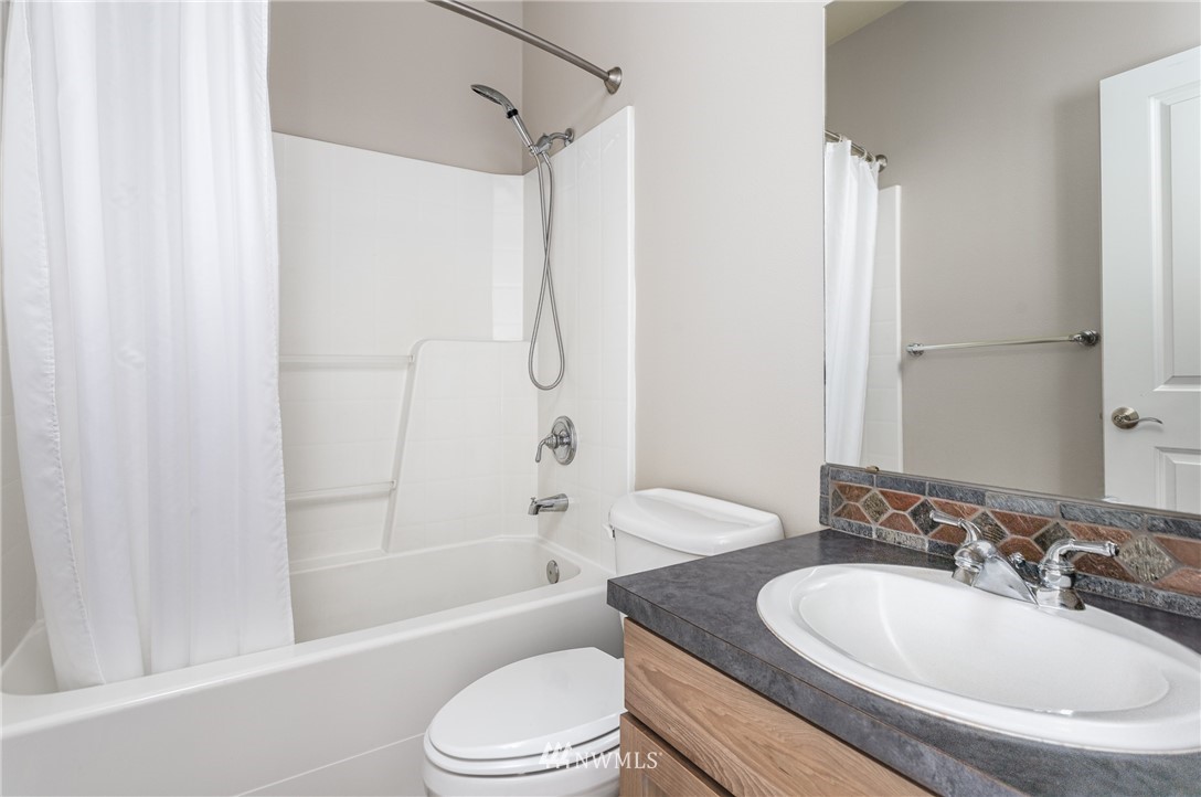 704 Firing Center Road Yakima, WA 98901 - Photo 23 of 29 a bathroom with a sink toilet and shower