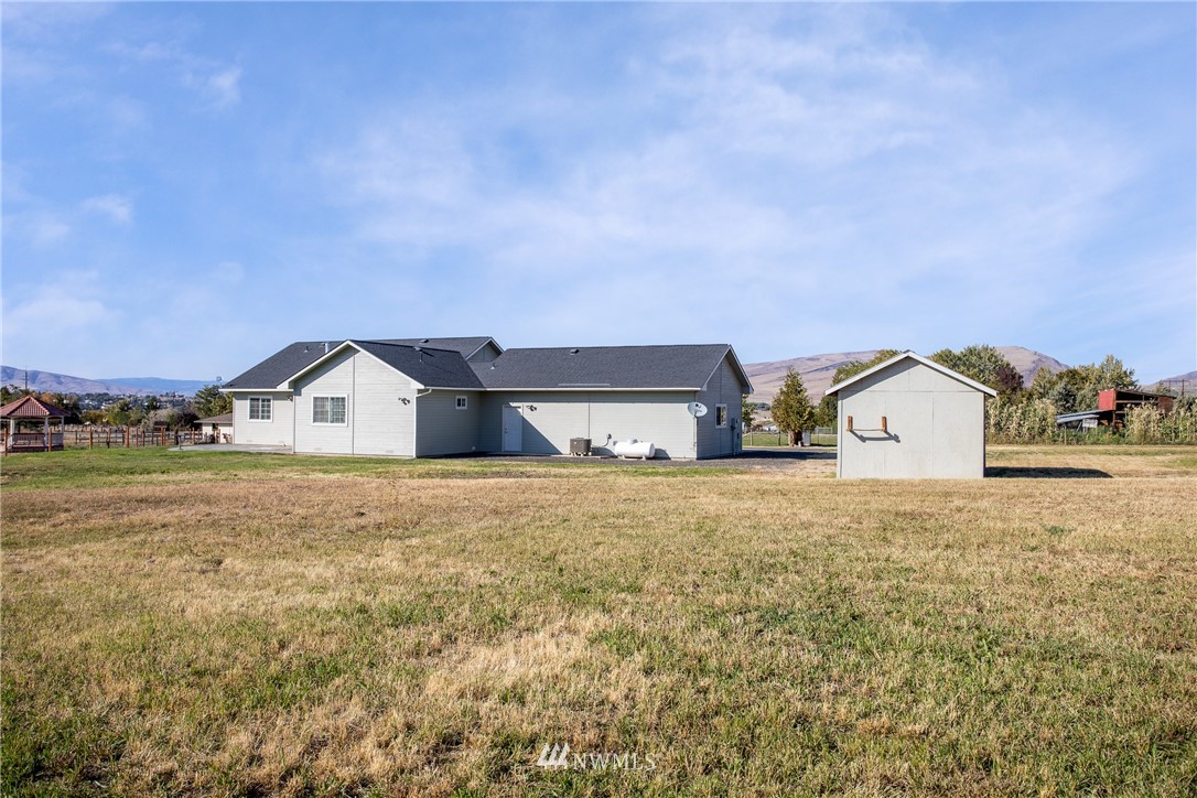 704 Firing Center Road Yakima, WA 98901 - Photo 25 of 29 a big house with a big yard and large trees