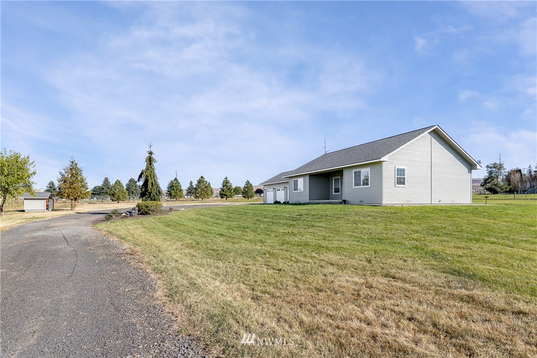 704 Firing Center Road Yakima, WA 98901 - Photo 4 of 29 a view of a house with a yard and palm trees