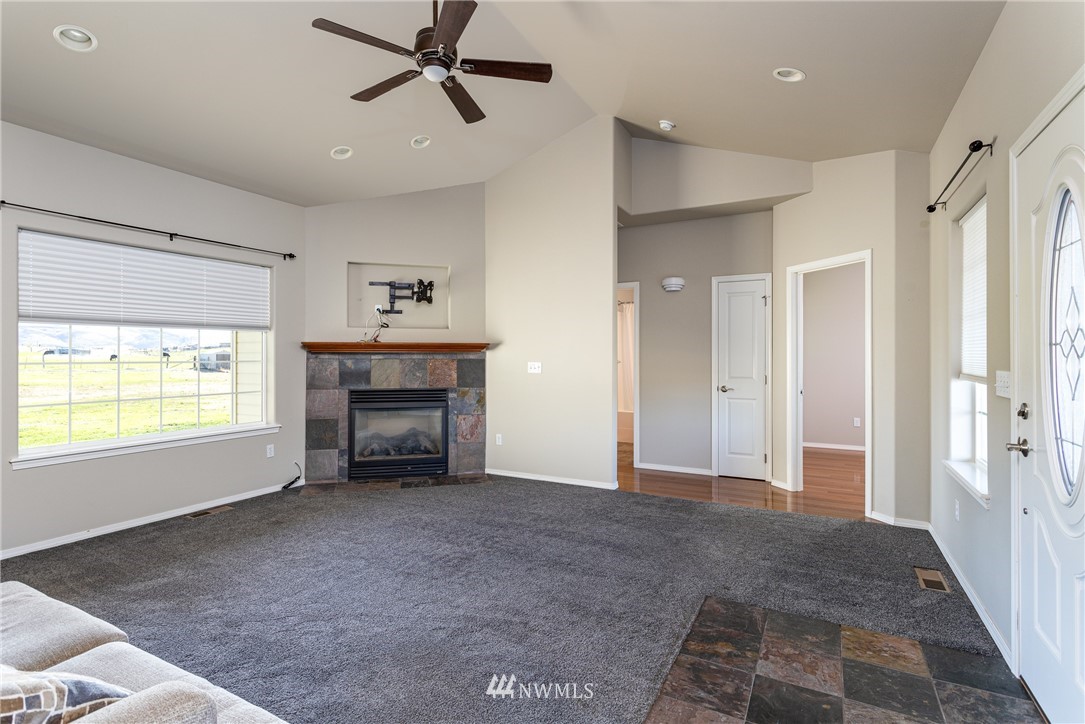 704 Firing Center Road Yakima, WA 98901 - Photo 9 of 29 a view of an empty room with a fireplace and a window