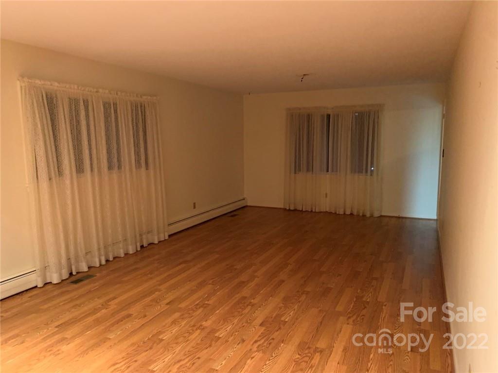 3170 Spring Garden Road, Unit 112 Claremont, NC 28610 - Photo 13 of 36 an empty room with wooden floor