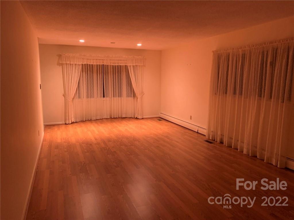 3170 Spring Garden Road, Unit 112 Claremont, NC 28610 - Photo 15 of 36 a view of an empty room with wooden floor