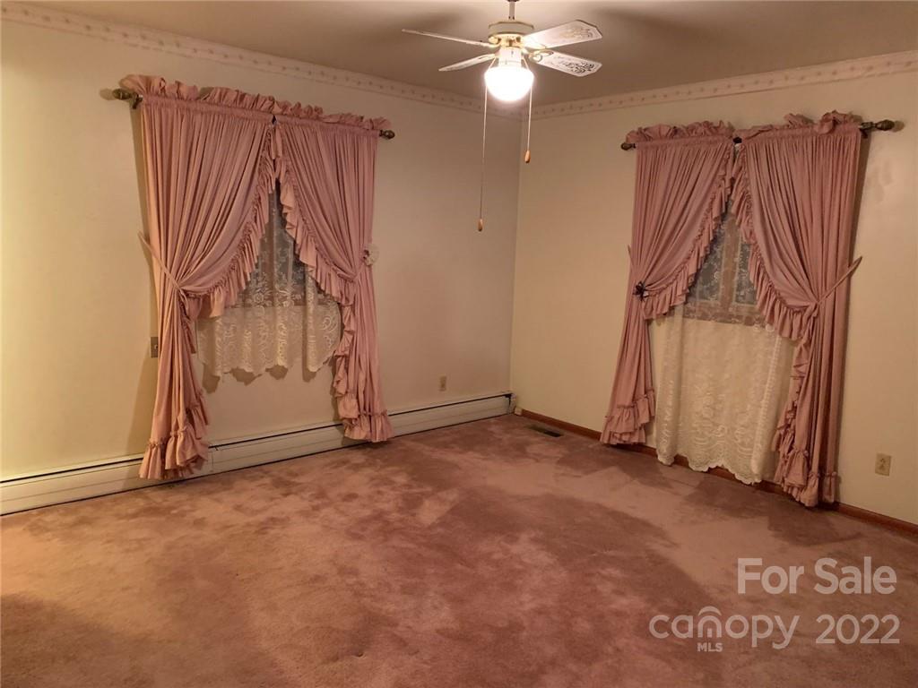 3170 Spring Garden Road, Unit 112 Claremont, NC 28610 - Photo 19 of 36 an empty room with a window and a fan