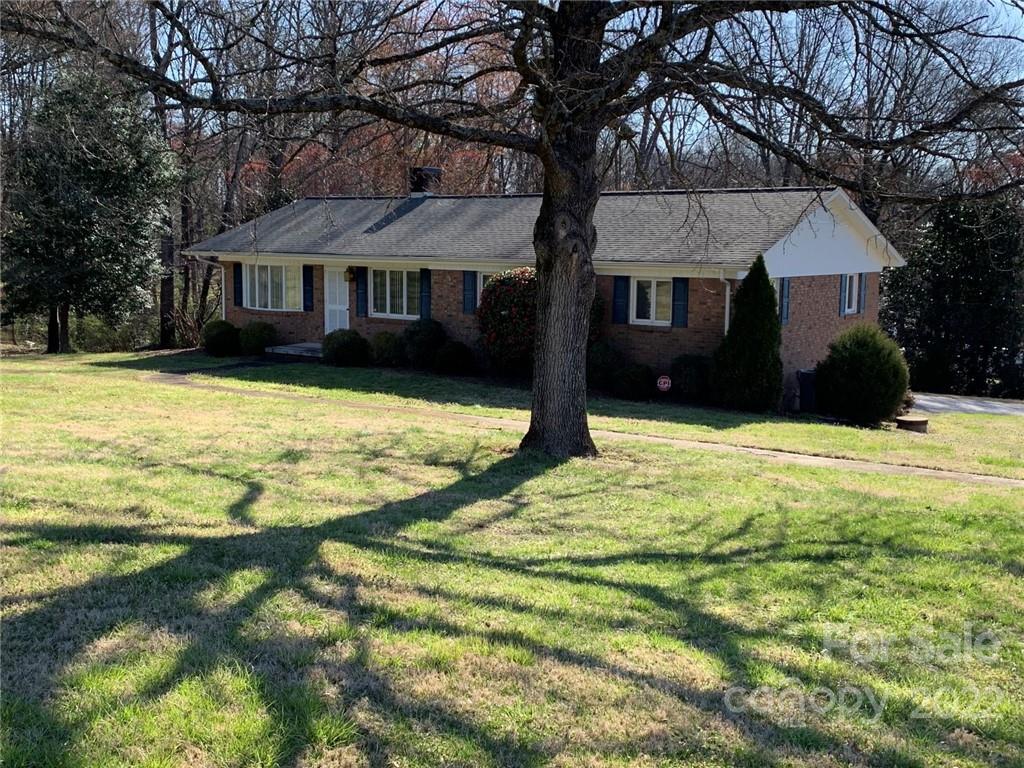 3170 Spring Garden Road, Unit 112 Claremont, NC 28610 - Photo 2 of 36 a front view of a house with a yard