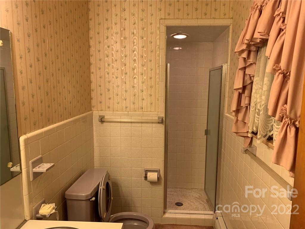 3170 Spring Garden Road, Unit 112 Claremont, NC 28610 - Photo 21 of 36 a bathroom with a shower and toilet