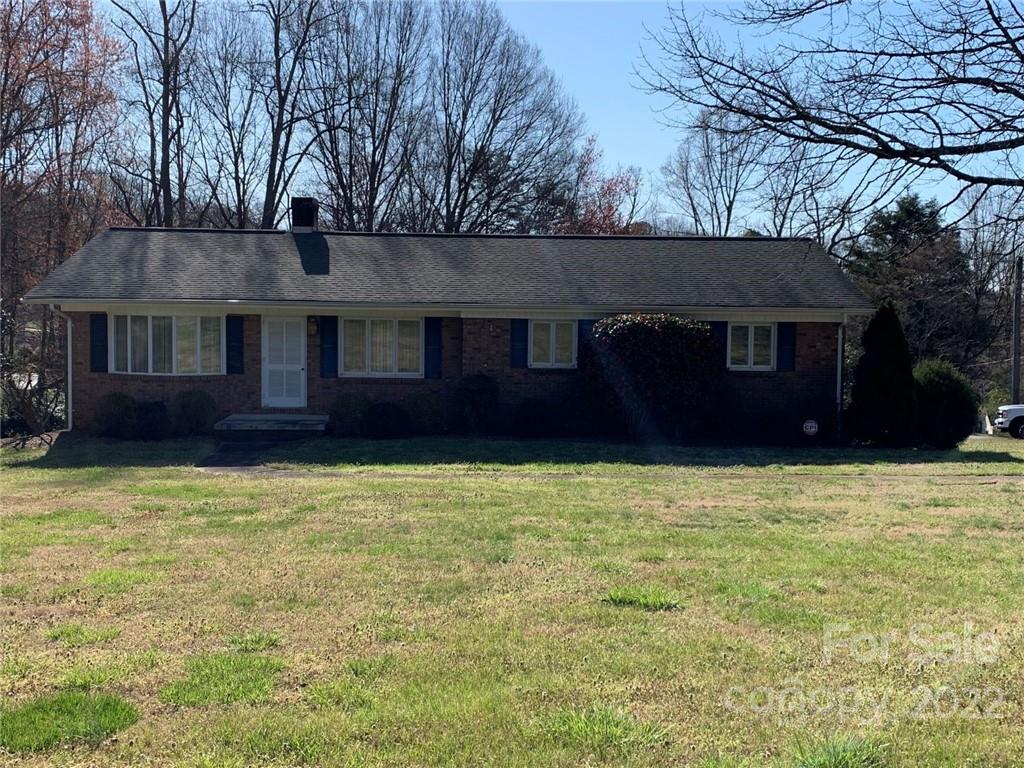 3170 Spring Garden Road, Unit 112 Claremont, NC 28610 - Photo 4 of 36 a house with a tree in front of it