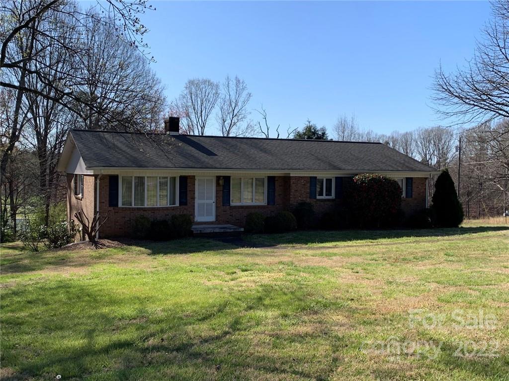 3170 Spring Garden Road, Unit 112 Claremont, NC 28610 - Photo 5 of 36 a view of a house with a yard