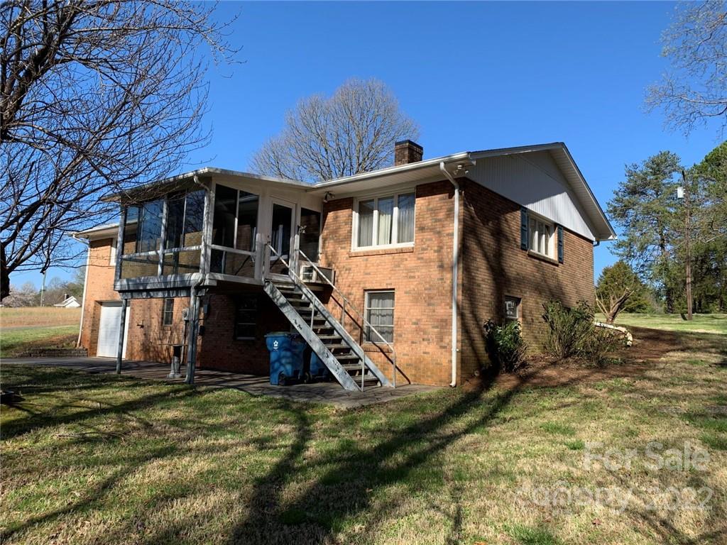 3170 Spring Garden Road, Unit 112 Claremont, NC 28610 - Photo 6 of 36 a front view of a house with a yard