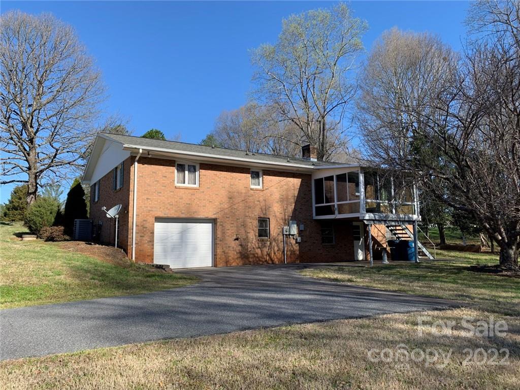 3170 Spring Garden Road, Unit 112 Claremont, NC 28610 - Photo 7 of 36 a front view of a house with a yard