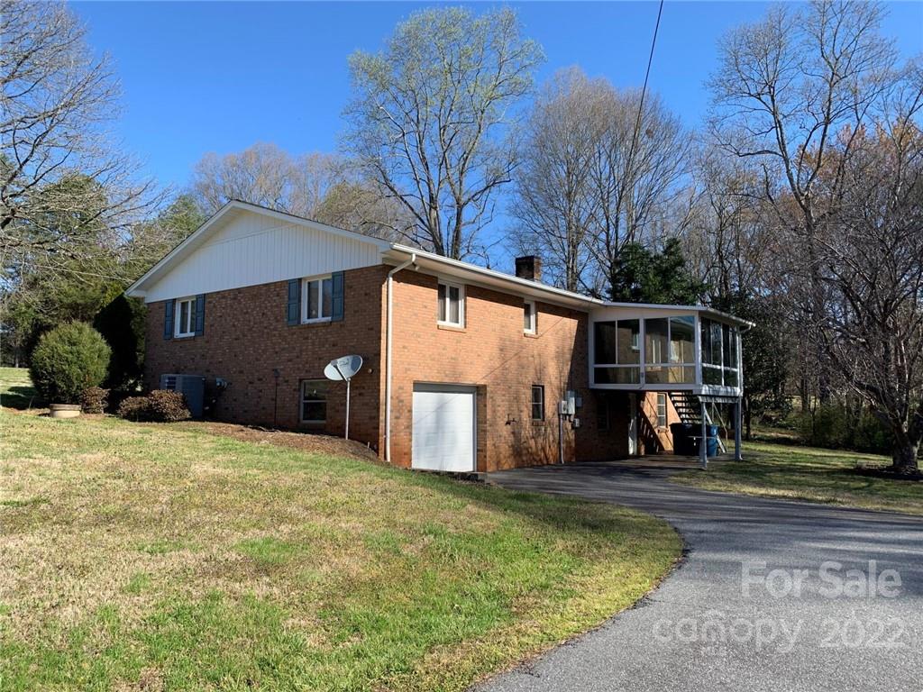 3170 Spring Garden Road, Unit 112 Claremont, NC 28610 - Photo 8 of 36 a view of a house with a yard