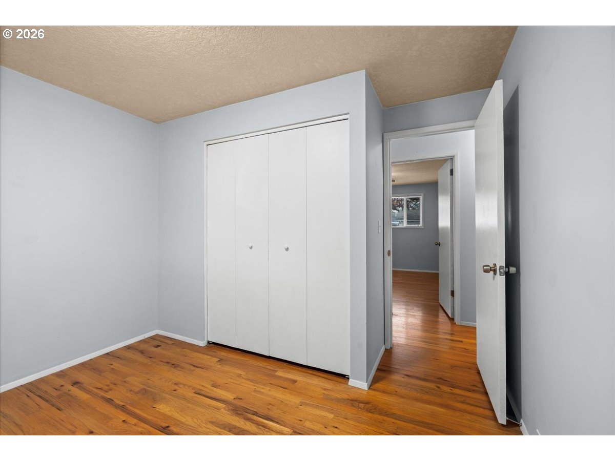 1386 Umpqua Road Woodburn, OR 97071 - Photo 17 of 32 a view of hallway with wooden floor