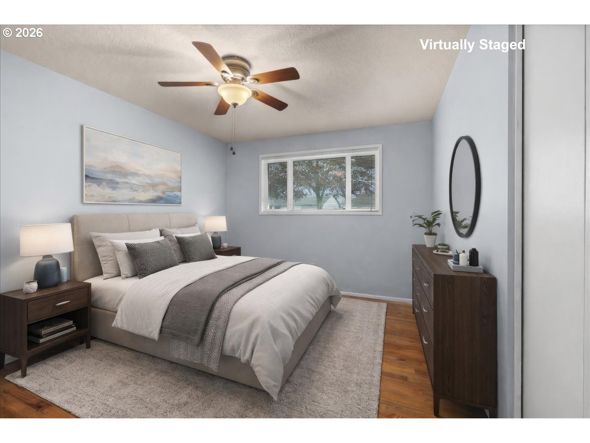 1386 Umpqua Road Woodburn, OR 97071 - Photo 19 of 32 a bedroom with bed and a chandelier