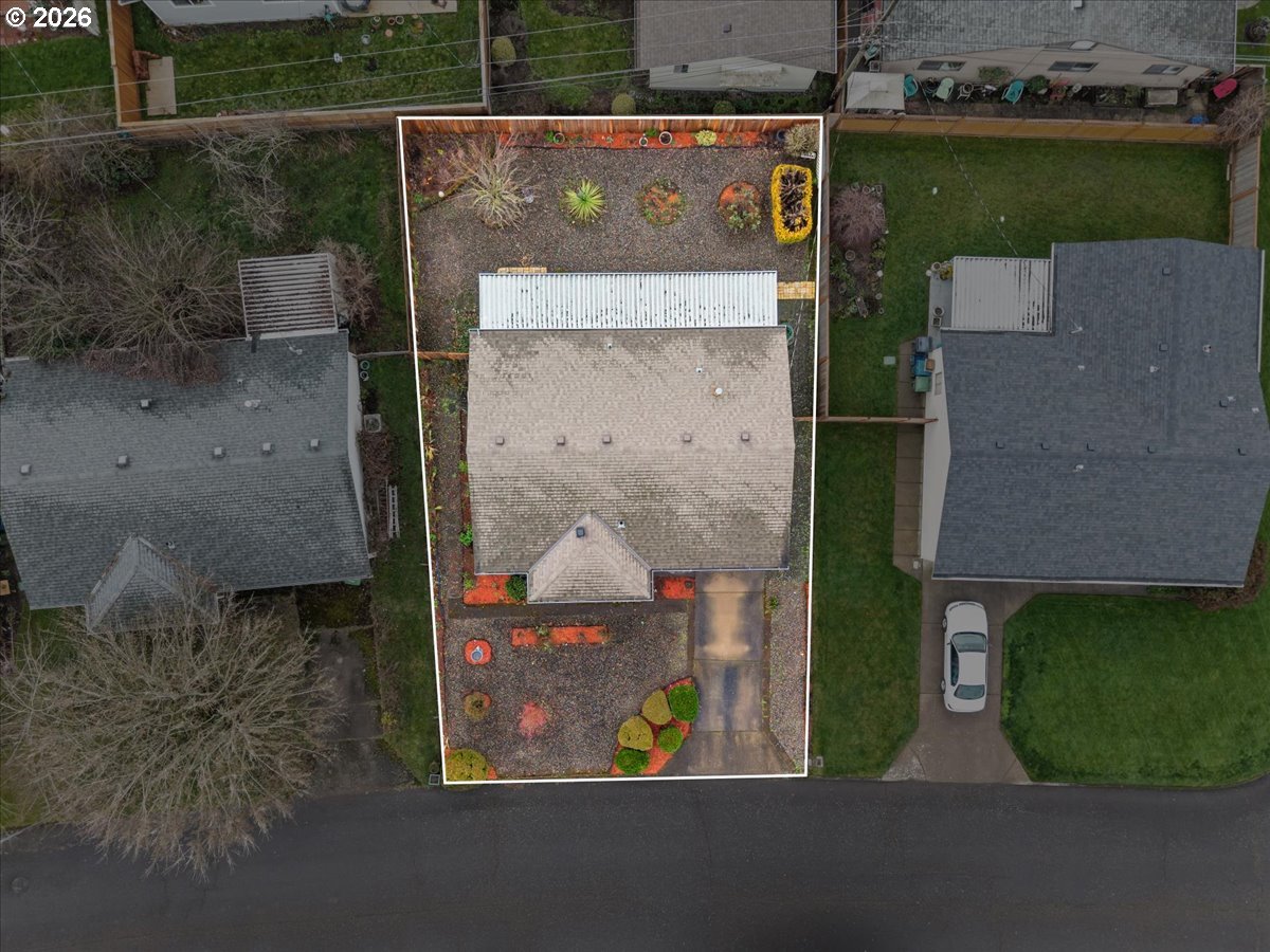 1386 Umpqua Road Woodburn, OR 97071 - Photo 31 of 32 an aerial view of a house with garden space and parking